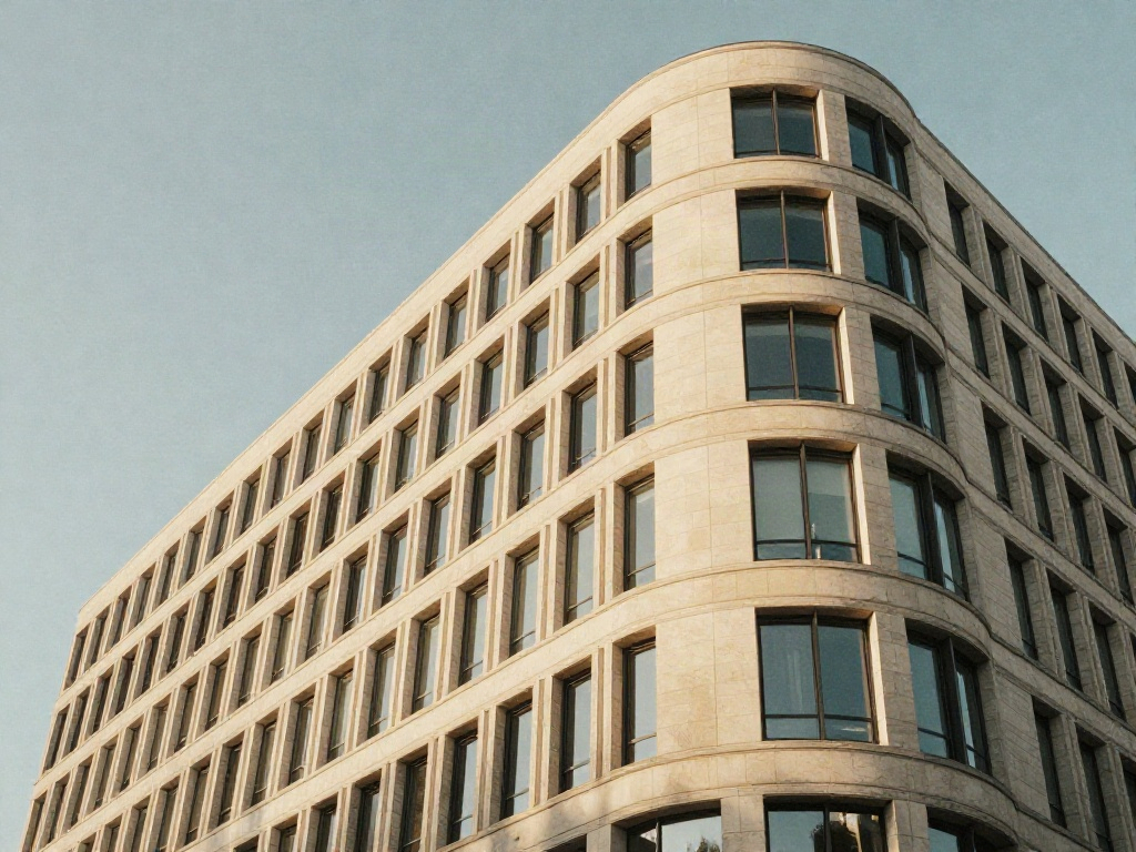 Upward perspective of a contemporary corporate building with rhythmic limestone and glass lines